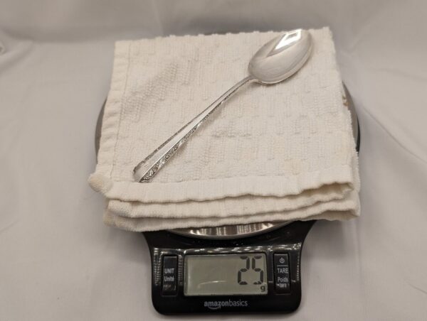 Vintage Towle teaspoon, monogrammed, on white towel