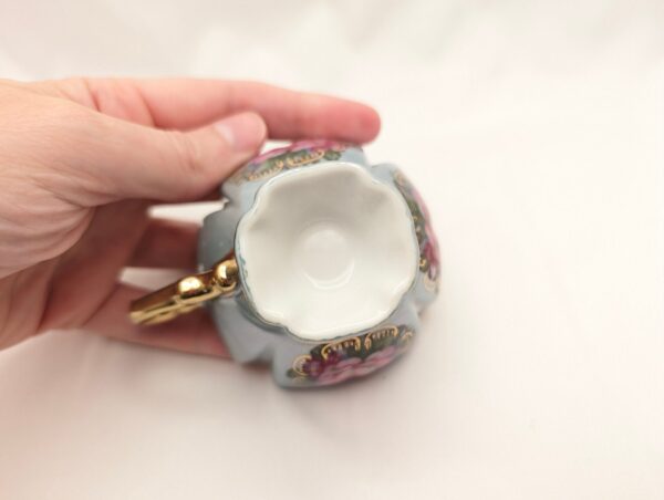 Vintage blue tea cup with roses, gold handle