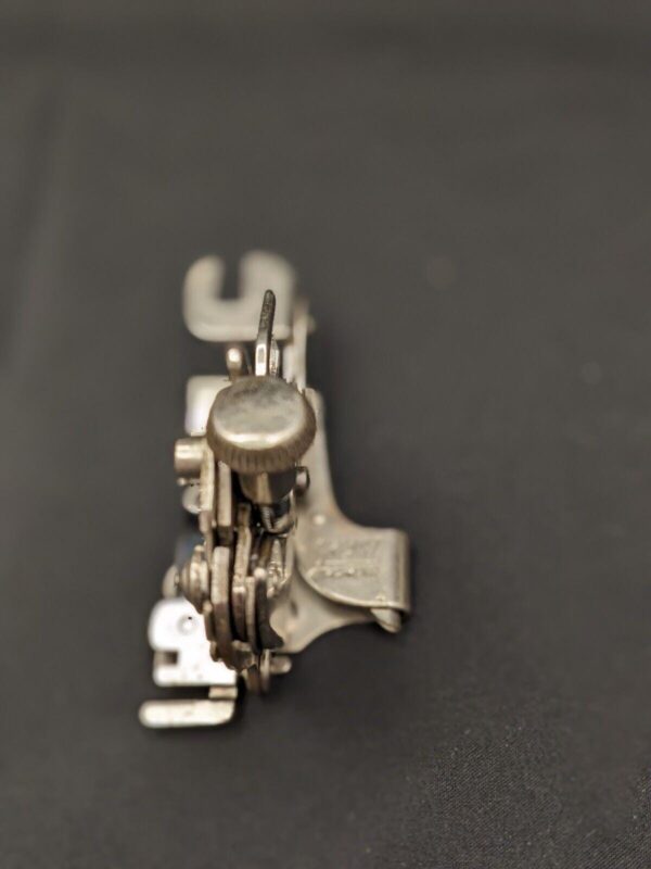 Vintage Greist Rotary 5-Stitch Ruffler Top Clamp. White Rotary, Working. Measures: L8 x W1.5 x H2.5 cm